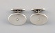 A pair of modernist Georg Jensen cufflinks in sterling silver and gold. Model 
number 200. Mid 20th century.
