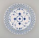 Antique Royal Copenhagen Blue fluted plate in openwork porcelain. Early 19th 
century.
