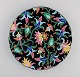 Longwy, France. Art deco plate in glazed stoneware with hand-painted flowers and 
foliage on a black background. 1920s / 30s.
