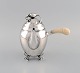 Georg Jensen Blossom coffee pot in hammered sterling silver with ivory handle. 
Model 2C. Dated 1915-1930.
