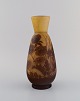 Antique Emile Gallé vase in dark yellow and light brown art glass carved in the 
form of flowers and foliage. Early 20th century.
