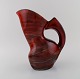 French studio ceramicist. Large abstract unique jug in glazed stoneware. 
Beautiful glaze in shades of red. 1960s / 70s.
