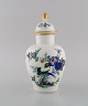 Meissen lidded porcelain vase with hand-painted flowers, birds and gold 
decoration. 250th anniversary. Dated 1960.
