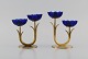 Gunnar Ander for Ystad Metall. Two candlesticks in brass and blue art glass 
shaped like flowers. 1950s.
