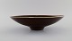 Carl Harry Stålhane (1920-1990) for Rörstrand. Large bowl / dish in glazed 
ceramica. Beautiful glaze in brown shades. Mid-20th century.
