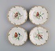 Four antique Royal Copenhagen side plates in porcelain with hand-painted 
flowers, butterflies and gold edge. Mid-19th century.
