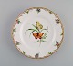 Antique Royal Copenhagen porcelain plate with hand-painted flowers, butterflies 
and gold edge. Mid-19th century.
