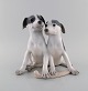 Large and rare Royal Copenhagen porcelain figure. Puppies with bone. Model 
number 750. Early 20th century.
