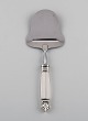 Georg Jensen Acanthus cheese slicer in sterling silver and stainless steel.
