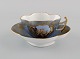 Helene Wolfson for Dresden. Antik kaffekop med underkop i håndmalet porcelæn med 
købmænd og gulddekoration. Ca. 1860.
