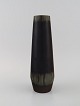 Carl Harry Stålhane (1920-1990) for Rörstrand. Vase in glazed ceramics with 
vertically incised pattern. Beautiful glaze in deep eggplant shades. Mid 20th 
century.

