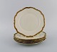KPM, Berlin. Five Royal Ivory lunch plates in cream-colored porcelain with gold 
decoration. 1920s.
