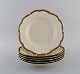 KPM, Berlin. Six Royal Ivory deep plates in cream-colored porcelain with gold 
decoration. 1920s.
