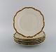 KPM, Berlin. Six Royal Ivory dinner plates in cream-colored porcelain with gold 
decoration. 1920s.
