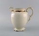 KPM, Berlin. Royal Ivory jug in cream-colored porcelain with gold decoration. 
1920s.
