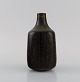 Eva Stæhr-Nielsen for Saxbo. Vase in glazed stoneware with vertically incised 
lines. Beautiful glaze in brown shades. Mid-20th century.
