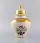 Rosenthal lidded vase in cream-colored porcelain with hand-painted flowers and 
gold leaf decoration. Mid-20th century.
