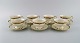 KPM, Berlin. Seven Royal Ivory tea cups with saucers in cream-colored porcelain 
with gold decoration. 1920s.
