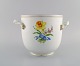 Meissen wine / champagne cooler in hand-painted porcelain with flowers and gold 
edge. Handles modeled as branches. Early 20th century.
