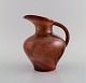 Richard Uhlemeyer (1900-1954), Germany. Jug in glazed ceramics. Beautiful glaze 
in metallic red shades. 1940s.
