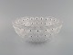 René Lalique art deco Nemours bowl in clear art glass modeled with flowers. Mid 
20th century.
