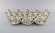 Minton, England. Tolv Haddon Hall mokkakopper med underkopper i porcelæn. 
Farverige blomster og lysegrøn kant. 1930