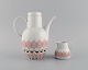 Bjørn Wiinblad for Rosenthal. Lotus porcelain service. Coffee pot with heater 
for tealight candles and creamer decorated with pink lotus leaves. 1980s.
