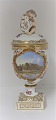 Lundin Antique præsenterer: Royal Copenhagen. Porcelæns ægvase med putti. Motiv : Botanisk Have. Højde 27 cm. ...