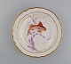 Royal Copenhagen porcelain dinner plate with hand-painted fish motif and golden 
border. Flora / Fauna Danica style. Dated 1955.
