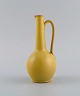 Bückeburg Keramik, Germany. Unique jug in glazed ceramics. Beautiful glaze in 
yellow shades. Mid-20th century.
