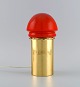 Hans Agne Jakobsson for A / B Markaryd. Brass table lamp with shade in red mouth 
blown art glass. Swedish design, 1960s / 70s.
