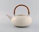 Eva Stæhr-Nielsen for Saxbo. Teapot in glazed stoneware with wicker handle. 
Model number 50. Mid 20th century.
