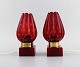 Hans Agne Jakobsson for A / B Markaryd. A pair of table lamps in brass and red 
mouth-blown art glass shaped like flower petals. Swedish design, 1960s / 70s.
