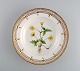 Royal Copenhagen Flora Danica dyb tallerken i håndmalet porcelæn med blomster og 
gulddekoration.
