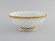 Antique Meissen bowl in openwork porcelain with hand-painted gold decoration. 
19th century.
