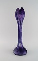 Daum Nancy, France. Large art nouveau vase in purple mouth-blown art glass. 
Organically shaped like a flower. Early 20th century.
