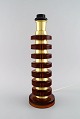 Swedish designer. Large table lamp in amber colored art glass and brass. 1970s.
