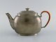 Just Andersen (1884-1943), Denmark. Art deco tin teapot with wicker handle. 
1940s. Model number 2421.
