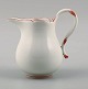 Meissen cream jug in white porcelain with red decoration.
Approx. 1930.