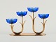 Gunnar Ander for Ystad Metall. Candlestick in brass and blue art glass shaped 
like flowers. 1950s.
