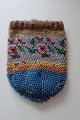 Antique little Handmade/purse/bag, made of beads
This beautiful old handmade bag/purse, from about 
the end of the 1800-years, is handmade of beads 
with embroidery which shows flowers/roses
The shape is with a possibility for cords at the 
top