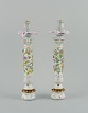Meissen, Germany, a pair of antique very tall candlesticks decorated with 
flowers and insects and numerous poufing flowers.
Rare and impressive candlesticks of high quality.