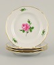 Meissen, Germany, four plates hand painted with flowers and gold decoration.