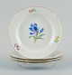 Meissen, Germany. Four porcelain plates hand-painted with various floral motifs 
and gold rim.