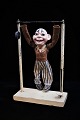 Decorative old clown doll in papier mache hanging on a gymnastic bar...