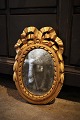 Decorative oval French early 19th century Louis d.XVI gilded wooden mirror with 
fine decorations...