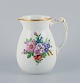 Bing & Grøndahl porcelain pitcher decorated with polychrome flowers and handle in the form of a seahorse.