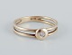 9 karat gold ring with a small diamond in a modernist design.
