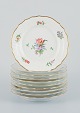 Royal Copenhagen, Saxon Flower, a set of ten small plates hand-decorated with 
polychrome flowers and gold rim.