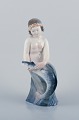 Royal Copenhagen, rare porcelain figurine of a mermaid holding fish in her 
hands.